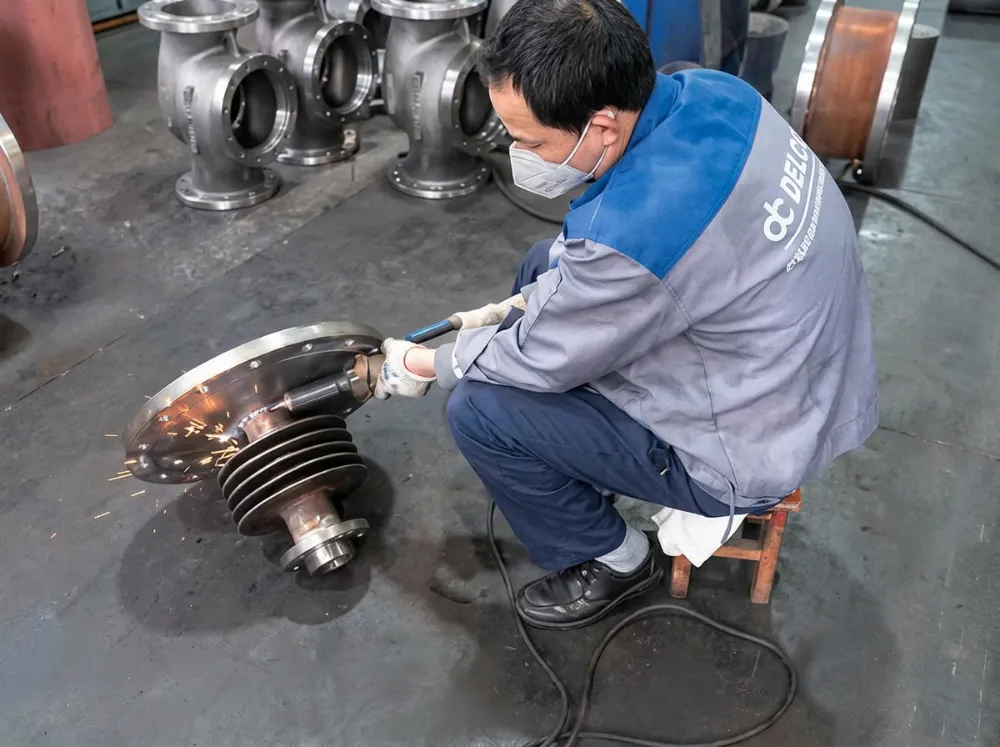 Grinding a cast valve component in the DELCO casting workshop