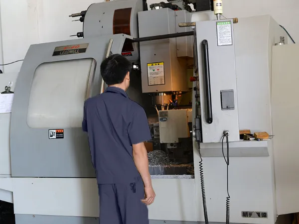 Operator at a CNC lathe in the machining workshop